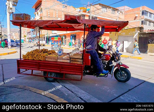 Huaraz, Ancash / Peru: 4. June 2016: farmer and merchant driving their motorcycle and stall to sell their corn at the market in Huaraz