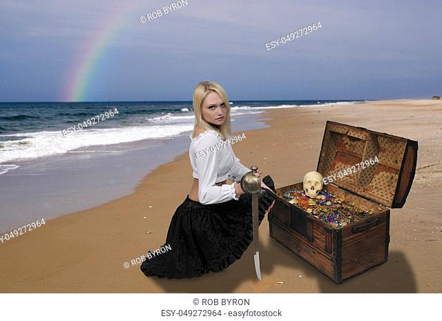 Beautiful young woman pirate opening a treasure chest