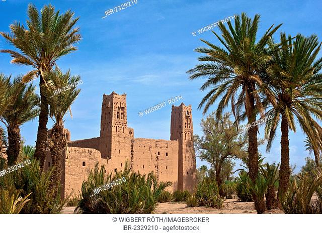 Decaying kasbah, mud brick fortress of the Berber people, Tighremt, surrounded by date palms (Phoenix), Skoura, lower Draa Valley, High Atlas range