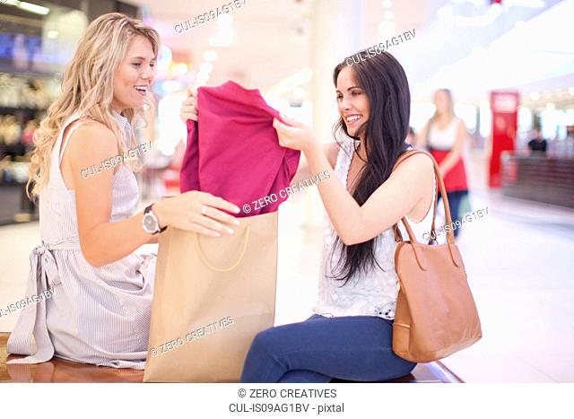 Young woman showing off new shirt