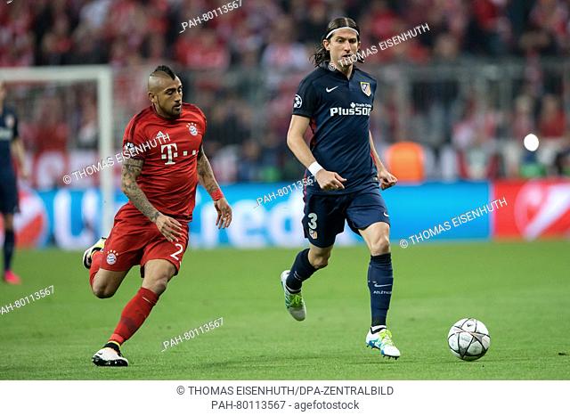 Bayern Munich's Arturo Vidal (l) and Madrid's Filipe Luis in action during the UEFA Champions League semi final soccer match FC Bayern Munich vs Atletico Madrid...