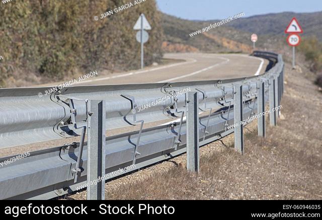 Guardrails poles covered crash-absorber beam. Roadside view. Motorists safety concept