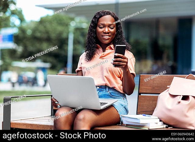 african student girl with laptop and smartphone