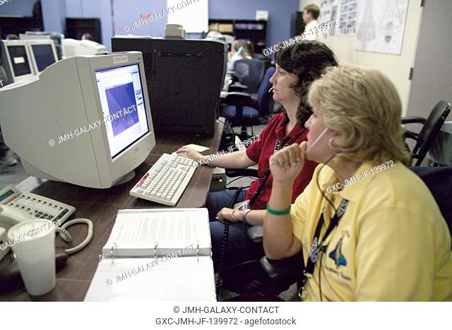 Cara Johnston (foreground) and Crystal Schroeder of the Photographic Operations Group process the latest images downlinked from STS-114 of the hand-held...
