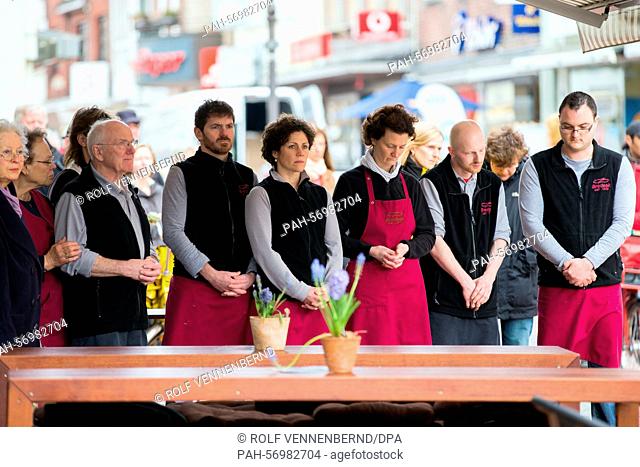Employees at a fish shop stand for a minute of silence for the victims of the airplane crash in the town center of Haltern am See, Germany, 26 March 2015