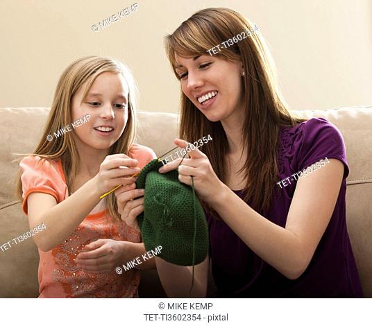 USA, Utah, Lehi, Mother giving daughter 8-9 knitting tips