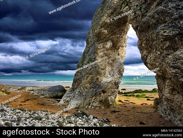 europe, northern ireland, county antrim, causeway coast, rock arch on the coast of the white rocks at portrush, intertidal zone, sand and pebble beach