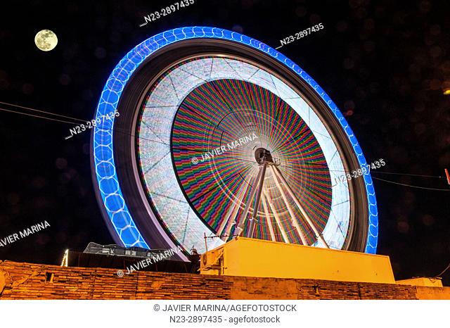 Ferris wheel and moon at the fair in Valencia, Valencian Community, Spain