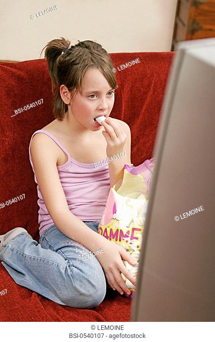CHILD SNACKING Model. 11-year-old girl