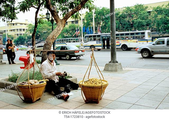 Street vendors in Bangkok makes a cigarette break
