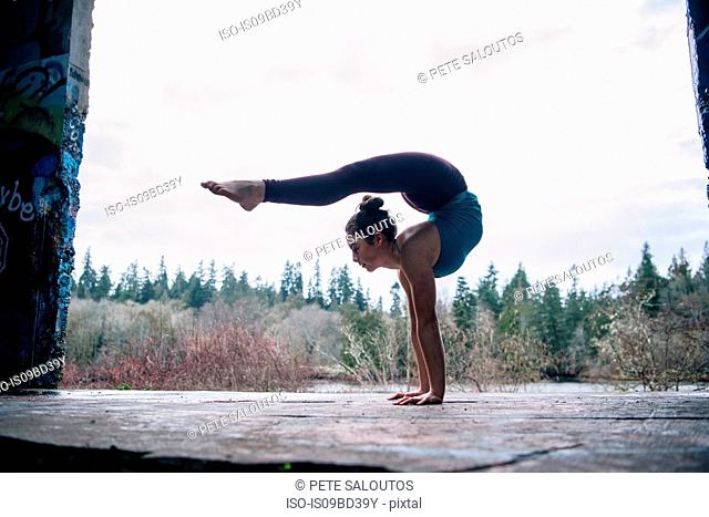 Girl practising yoga on outdoor stage