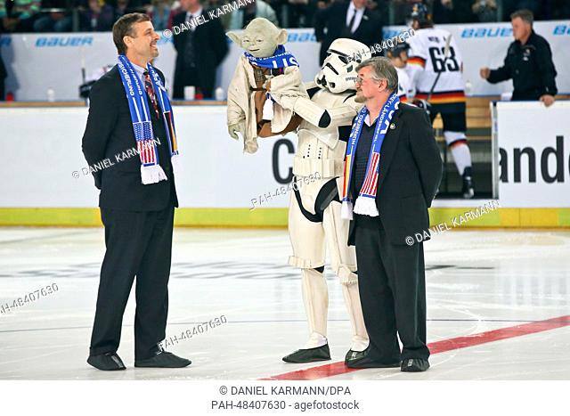 US consul general in Munich, Bill Moeller (L-R) stands on the ice with a man in a Star Wars Stormtrooper costume who holds up a Yoda Star Wars puppet and the...