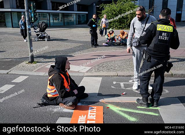 Berlin, Germany, Europe - A climate protester of the so-called Last Generation (Letzte Generation) has glued himself along with other participants to a roadway...