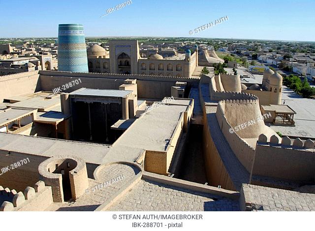 View onto the roofs of the old town with Ko'xna Ark Palace and the unfinished minaret Kaltar Minor Itchan Kala Khiva Uzbekistan