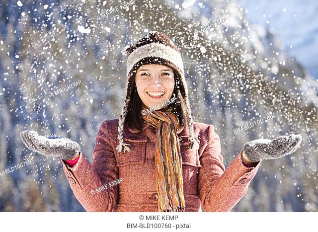 Caucasian woman standing in snowfall