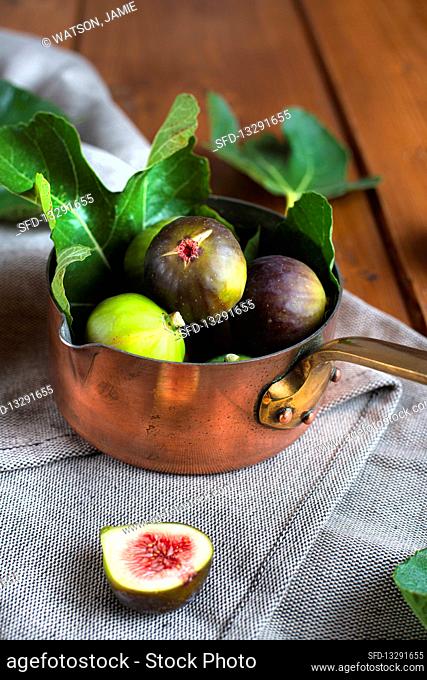 Copper pan filled with fresh figs
