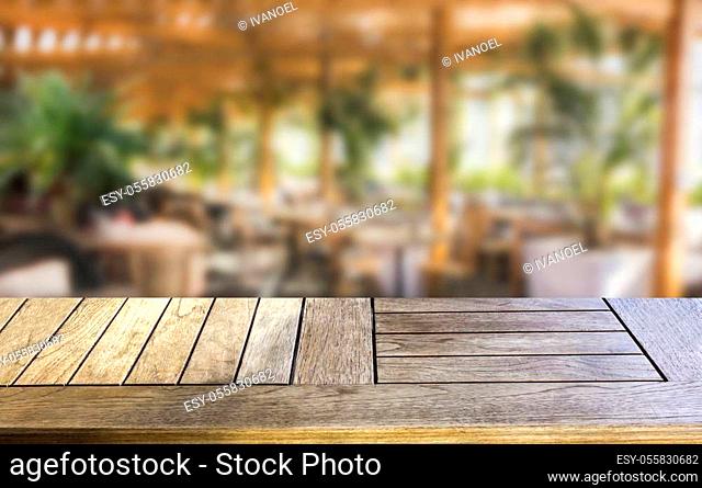 Wood table top on blur cafe background can be used for display or montage various products