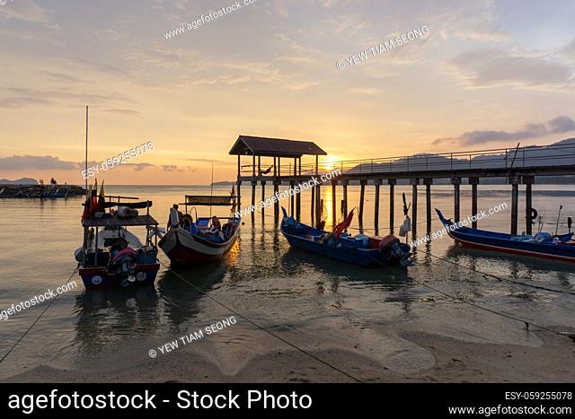 George Town, Penang/Malaysia - Mar 26 2017: Fisherman boat at jetty during amazing sunset sky