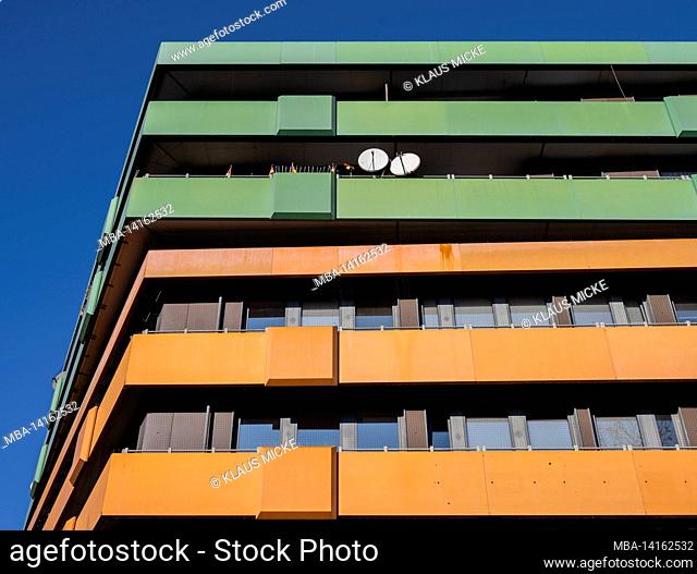colorful house facade, blue sky, satellite dishes