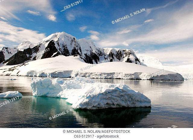 Reflections and snow covered mountains in Lemaire Channel in Antarctica