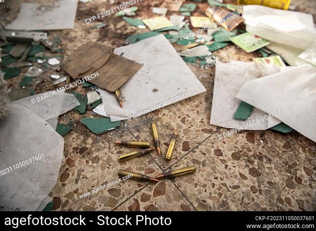 Shot cartridges from automatic weapons are still lying on the ground. Charred and destroyed buildings of Kibbutz Kfar Aza after a brutal attack by the terrorist...