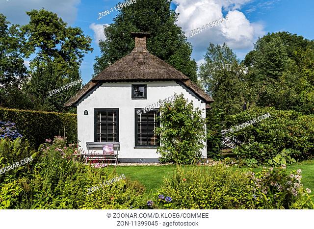 Giethoorn, The Netherlands - July 30, 2016: Front of thatched, white, monumental house in the small, picturesque town of Giethoorn, Overijssel, Netherlands