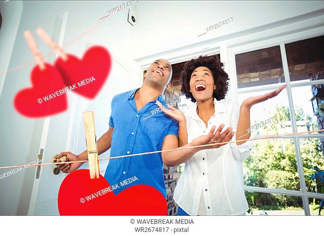 Couple entering home decorated with hearts