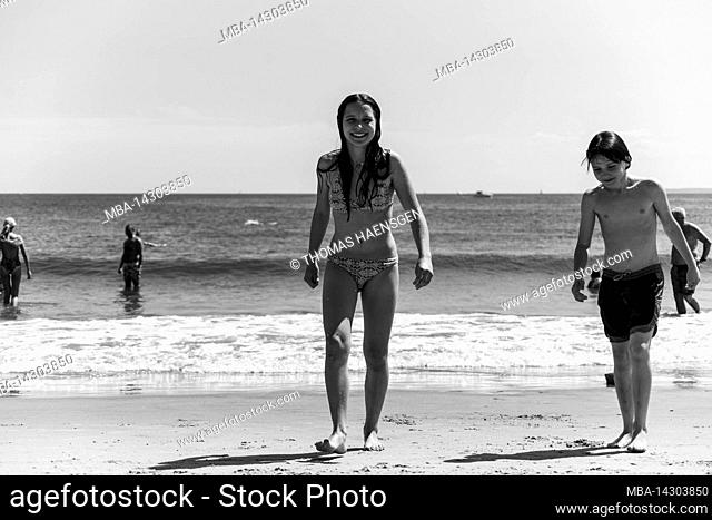 CONEY ISLAND, New York City, NY, USA, 14 years old caucasian teenager girl and 12 years old caucasian teenager boy - both with brown hair and in bathing outfit...