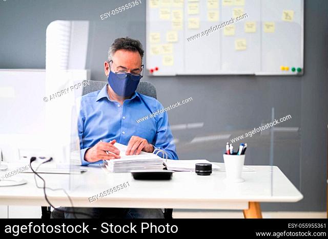 Elder Business Employee Working At Computer Wearing Facial Mask