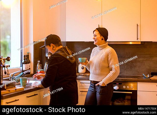 same sex couple, two women at home in kitchen