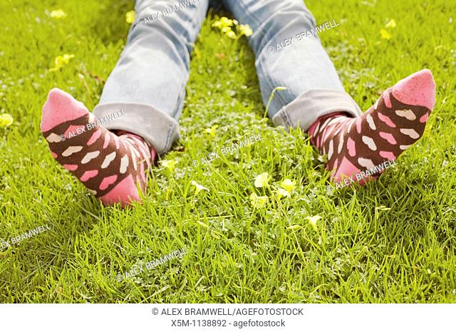 Woman on a green lawn with decorative socks