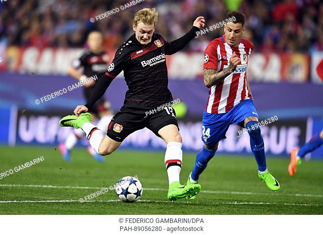 Madrid's Jose Maria Gimenez (r) and Leverkusen's Julian Brandt in action during the Champions League knock-out round of 16 match between Atlético Madrid and...