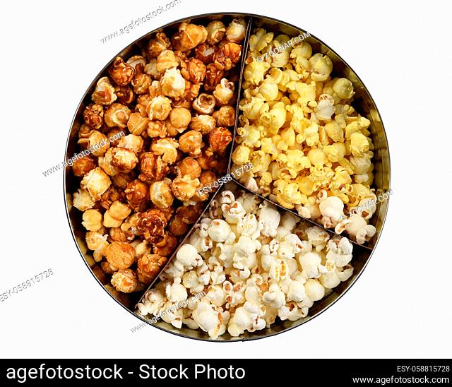 Three different styles of popcorn, buttered, cheese, and caramel, in a round tin. High angle isolated on white