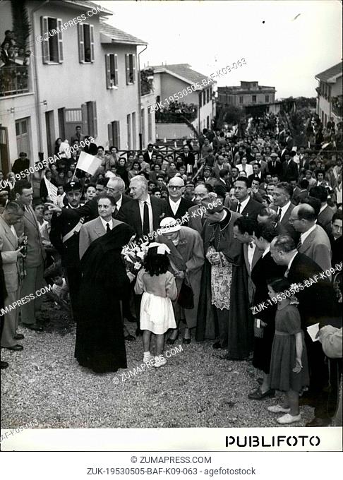 May 05, 1953 - Ambassador Clara Boothe Luce receives bouquet of flowers from a child of the village. Note way the villagers of Scilla packed the rooftops to see...