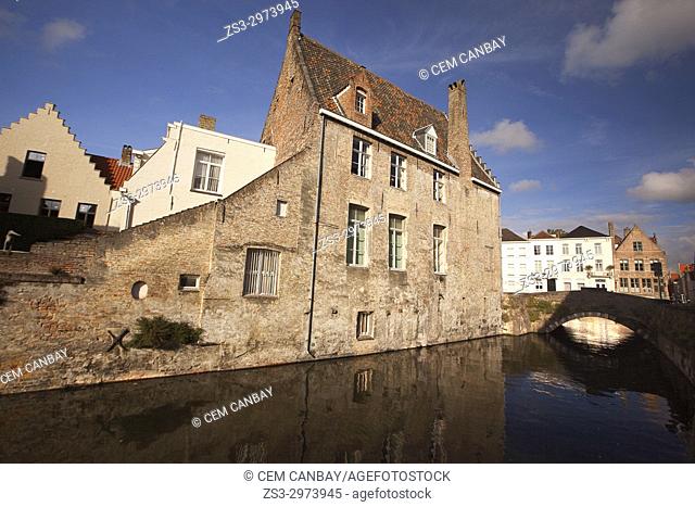 Houses, reflections and bridge on the canal in the city center, Bruges, West Flanders, Belgium, Europe