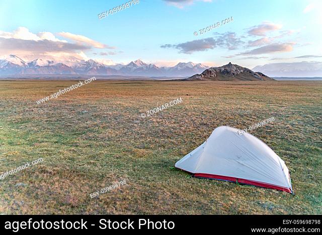 The amazing wild view of kyrgyzstan landscape full of snow peaks, wilderness and tent