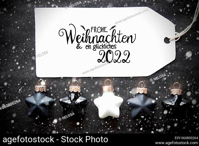Label With German Calligraphy Frohe Weihnachten Und Ein Glueckliches 2022 Means Merry Christmas And A Happy 2022. Black Christmas Ball Ornament With Snowflakes