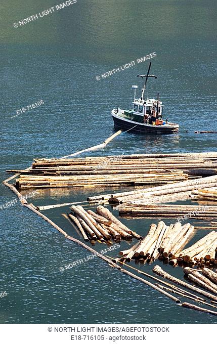 Log boom boats organizing logs at Adans Lake saw mill, BC, Canada