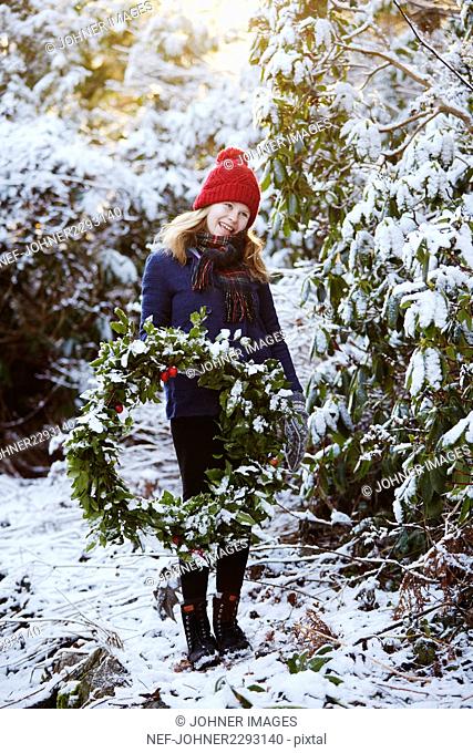 Girl holding Christmas wreath