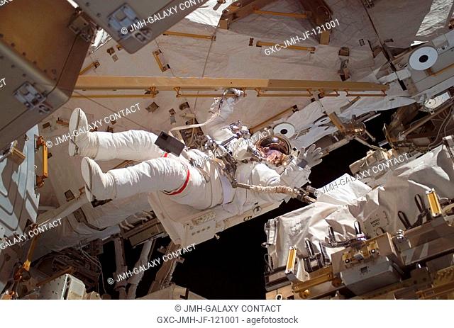 Astronaut Clay Anderson, Expedition 15 flight engineer, waves to the camera while participating in a session of extravehicular activity (EVA) as construction...