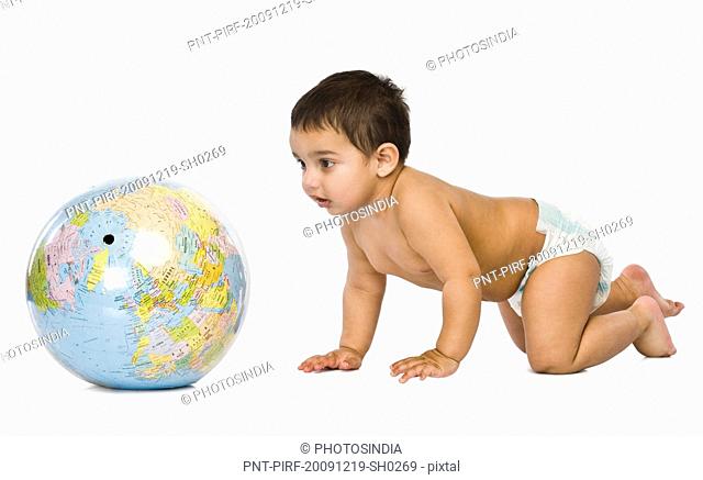 Baby boy playing with a globe