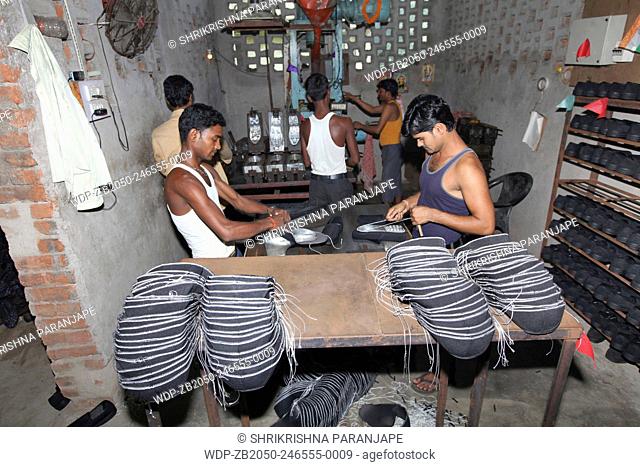 Shoe makers working making shoes in urban village, District Hazaribaug, Jharkhand, India