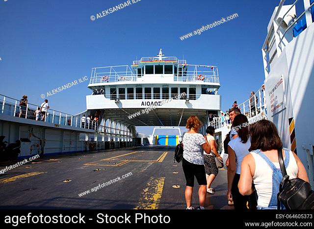 Agiokampos, Evia island, Greece - August 15, 2023: People on summer vacation entering ferryboat at Agiokampos, Evia ilsand