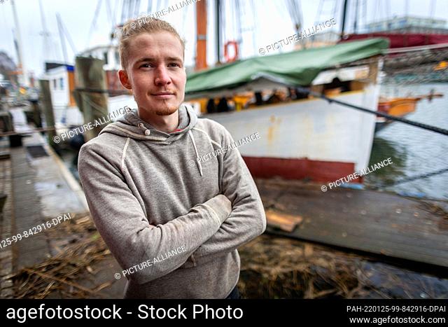 25 January 2022, Mecklenburg-Western Pomerania, Greifswald: Boat builder Florian Woll stands in front of the 1939-built mission cutter ""Elida"" at the museum...