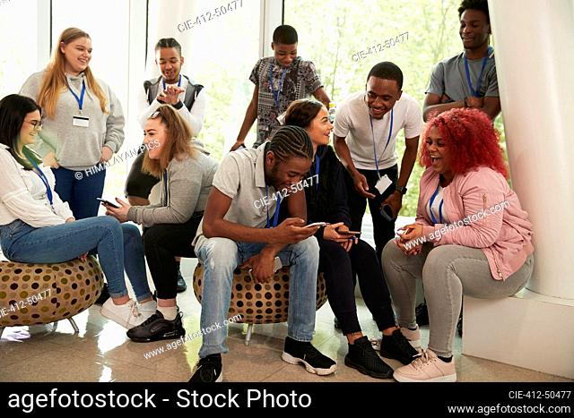 High school students hanging out and using smart phones