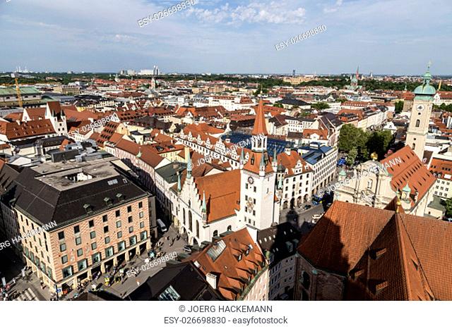 Beautiful super wide-angle sunny aerial view of Munich, Bayern, Bavaria, Germany with skyline and scenery beyond the city, seen from the observation deck of St