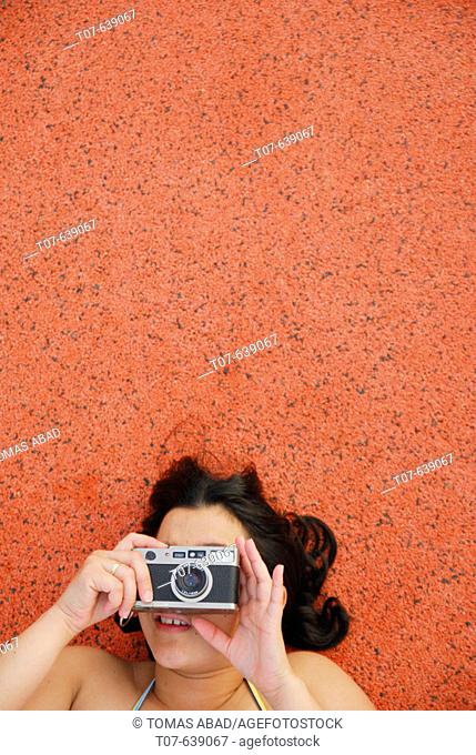 Latino Woman holding a camera