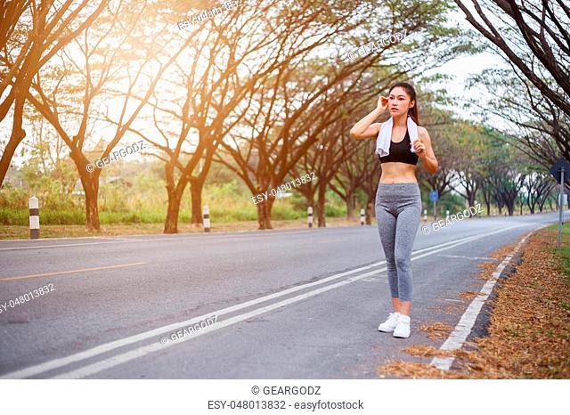 tired sporty woman after workout sport exercises outdoors at the park