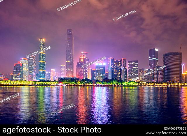 Guangzhou cityscape skyline over the Pearl River illuminated in the evening. Guangzhou, China