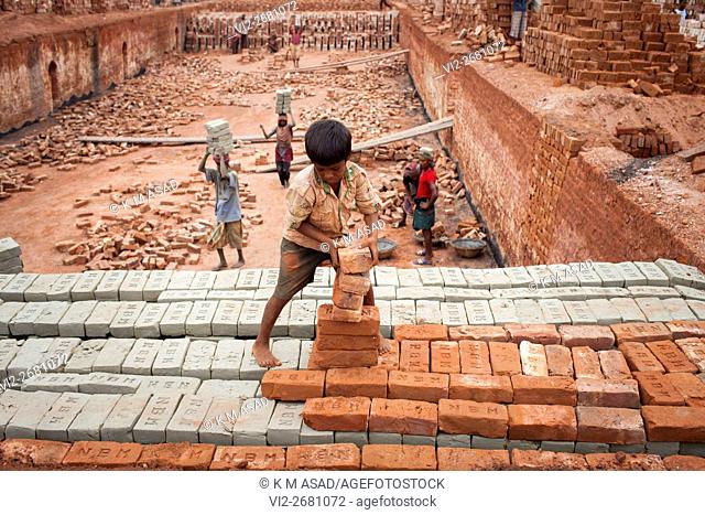 Babu (08) works at a brick factory in Narayangonj, Bangladesh, Jun 01, 2016. He come this place with his family member. This group of people comes from...